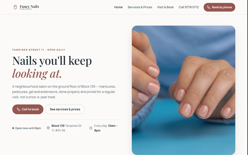 The Fancy Nails Paradise homepage: &lsquo;Nails you&rsquo;ll keep looking at&rsquo; beside a close photograph of hands with a soft natural manicure on a pale blue surface.