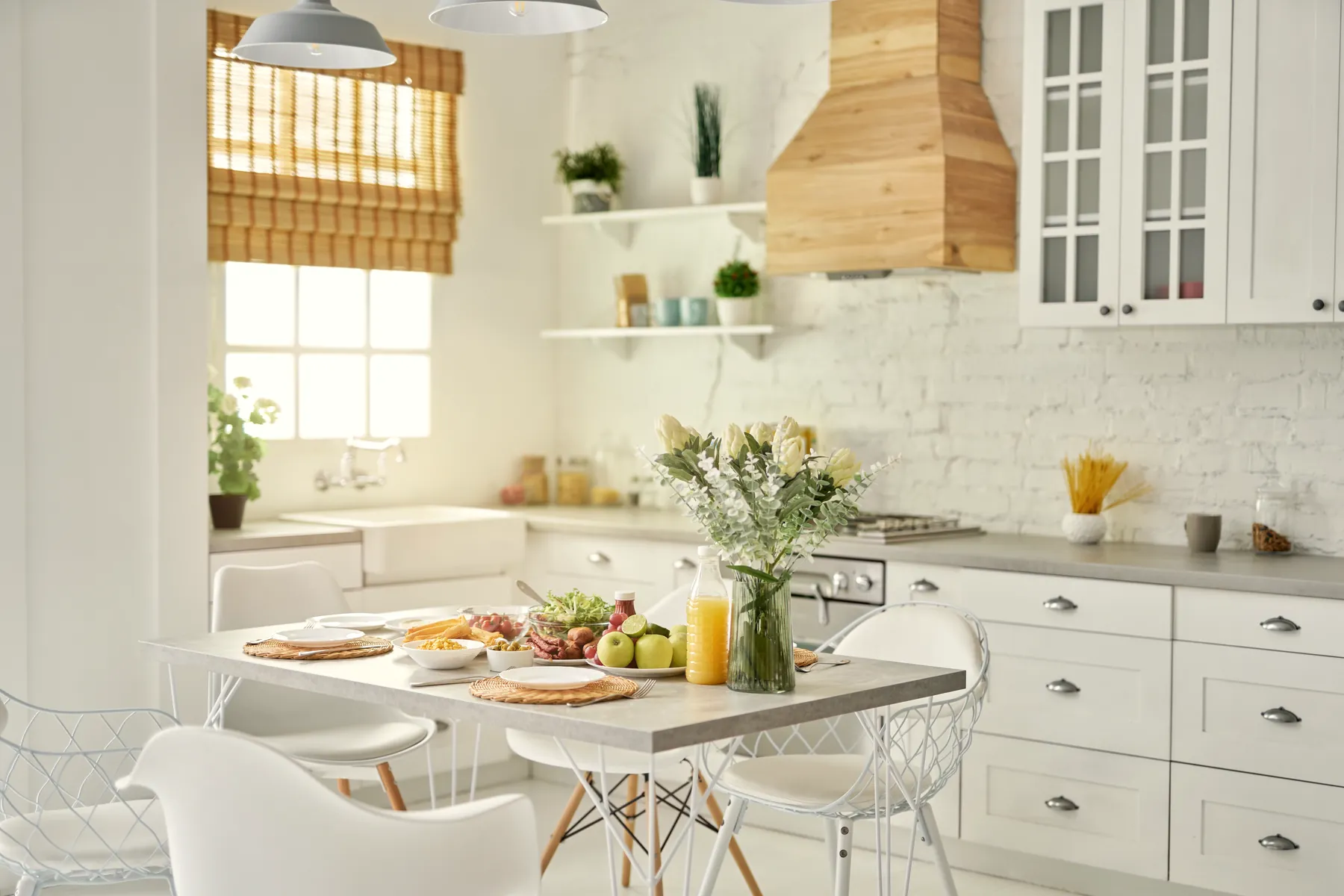 A bright farmhouse kitchen, breakfast laid on the table by a sunlit window.