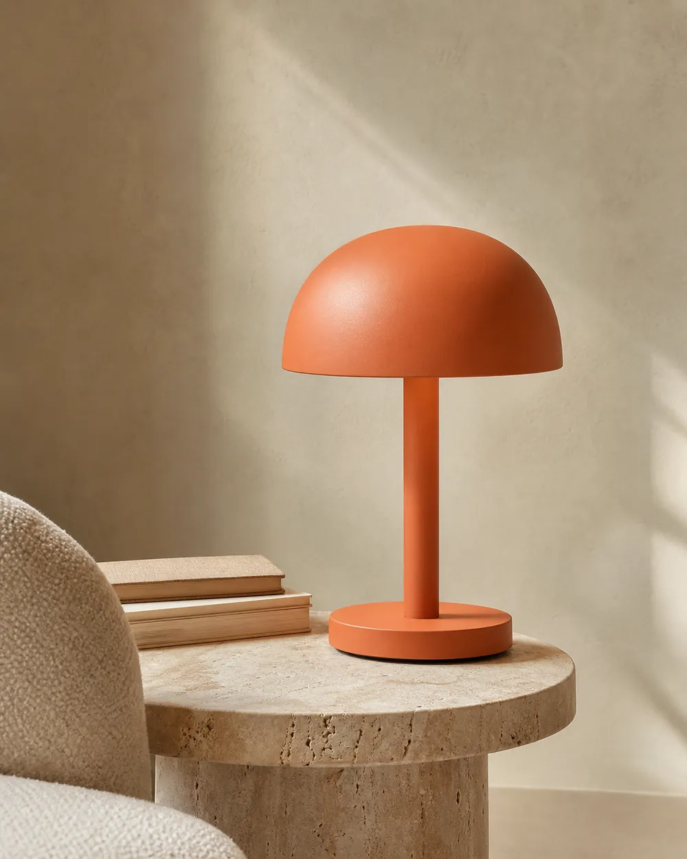 Persimmon orange Halo table lamp on a travertine side table