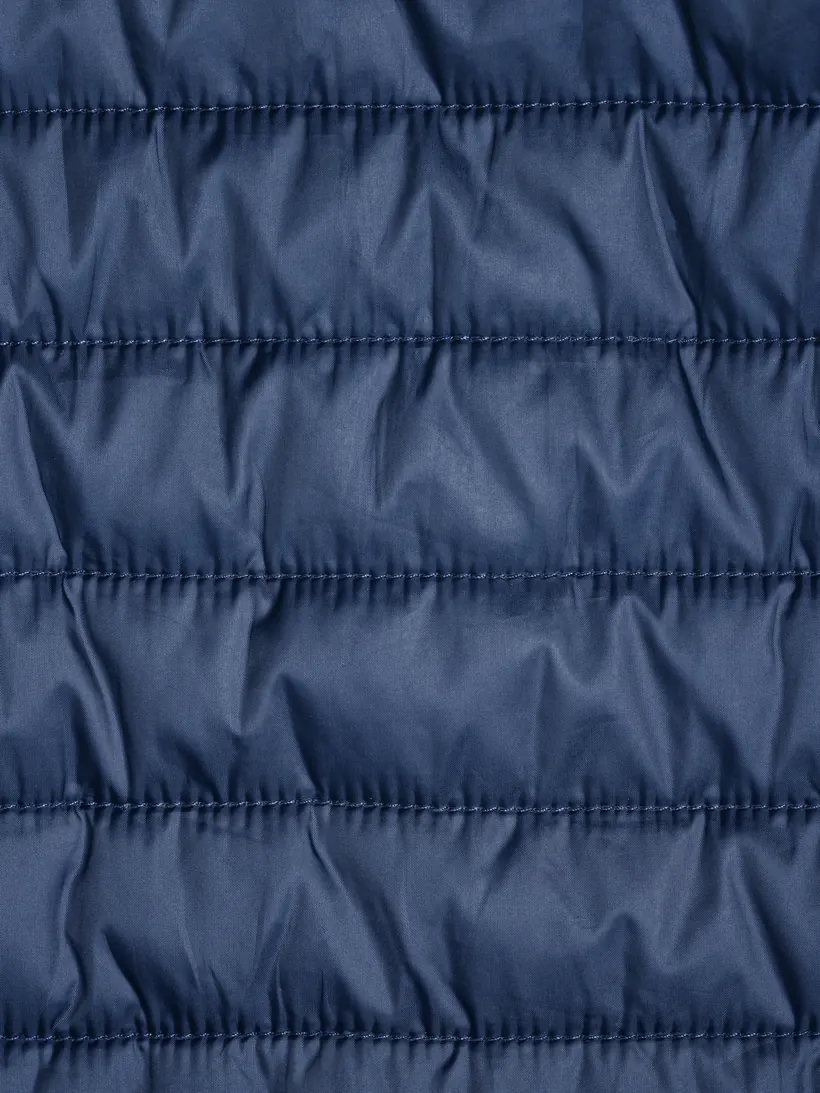 Macro of navy quilted stitch channels.