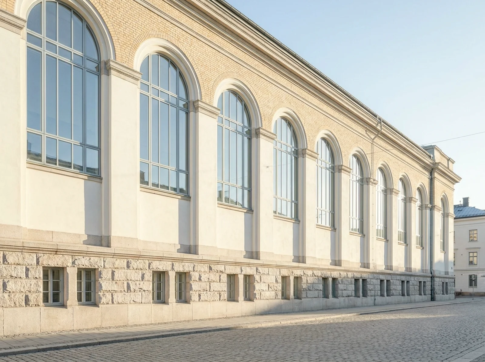 The Meridian Hall: a dignified early-1900s hall with one grand storey of tall arched windows above a rusticated stone base.